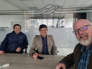 Alejandro, José, and Rob in the board room of the Bogotá office